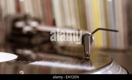 Dj needle stylus on spinning record, vinyl background Stock Photo