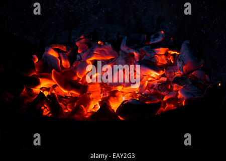 Burning charcoal in the dark, outdoors Stock Photo