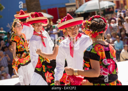 Traditional costumed Istmo folk dancers perform outside the Santo Domingo church during the Day of the Dead Festival known in spanish as D’a de Muertos on October 26, 2014 in Oaxaca, Mexico. Stock Photo