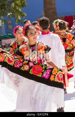 Traditional costumed Istmo folk dancers perform outside the Santo Domingo church during the Day of the Dead Festival known in spanish as D’a de Muertos on October 26, 2014 in Oaxaca, Mexico. Stock Photo
