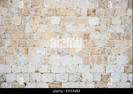 Old textured stone wall background in textured white Istrian marble on the Stradun in Dubrovnik Croatia Stock Photo