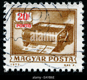 HUNGARY - CIRCA 1973: A stamp printed in Hungary from the 'Postal Operations' issue shows a money-order cancelling machine, circ Stock Photo