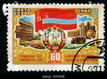 USSR - CIRCA 1984: A stamp printed in the USSR shows 60th anniversary of the Communist Party of the Uzbek Soviet Socialist Stock Photo