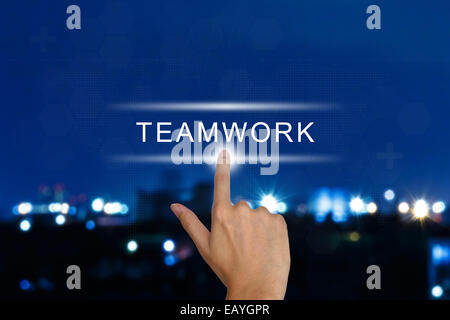 hand clicking teamwork button on a touch screen interface Stock Photo