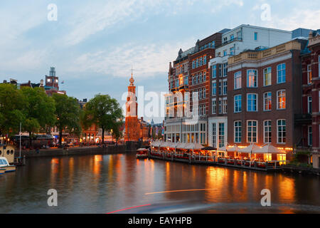 Night city view of Amsterdam canal, bridge and Munttoren tower, Holland, Netherlands. Stock Photo