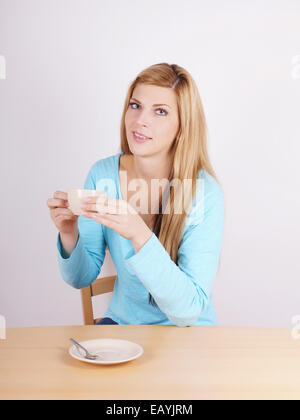 young woman drinking cup of coffee Stock Photo