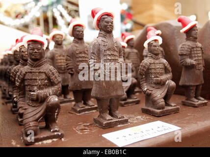 Xi'an, China's Shaanxi Province. 23rd Nov, 2014. A squad of chocolate miniature Terracotta Warriors wearing Santa hats stand on display at a hotel in Xi'an, capital of northwest China's Shaanxi Province, Nov. 23, 2014. Pastry chefs of a hotel in Xi'an have turned 100 kilograms of chocolate into miniatures imitative of members of the Terracotta Army, a set of lifesize ancient Chinese army sculptures from the 3rd century B.C., with Santa hats attached to the miniatures to mark the upcoming Christmas. © Jiao Hongtao/Xinhua/Alamy Live News Stock Photo