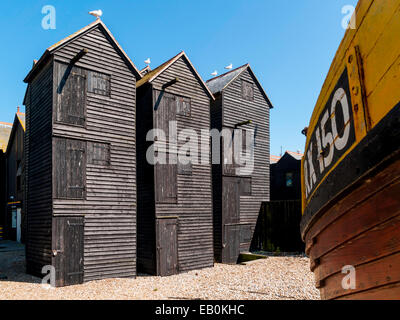 Traditional tall wooden huts for fishing net storage East Cliff Hastings UK Stock Photo