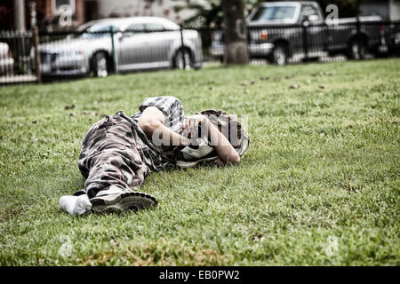 Homeless man sleeping in a park bench Stock Photo - Alamy