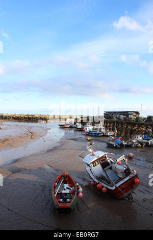 fishing and rowing boats moored in Bridlington harbour with the tide out Stock Photo