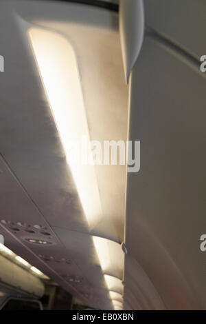 Fine mist coming out of the air conditioning system aboard a commercial airplane Stock Photo