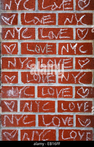 LOVE NYC chalk graffiti on a red brick wall Stock Photo