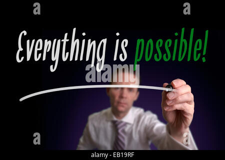 A businessman writing Everything is Possible on a screen. Business Concept. Stock Photo