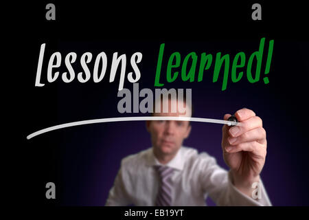 A businessman writing Work With Us Not Against Us on a screen. Business Concept. Stock Photo