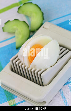 Hard boiled egg in egg slicer, closeup Stock Photo