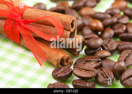cinnamon sticks with red ribbon and coffee beans Stock Photo