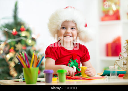 child making christmas tree of plasticine Stock Photo