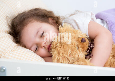 Pretty kid girl sleeping in bed Stock Photo