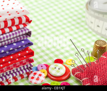 https://l450v.alamy.com/450v/eb1kjt/sewing-items-buttons-colorful-fabrics-measuring-tape-pin-cushion-thimble-eb1kjt.jpg