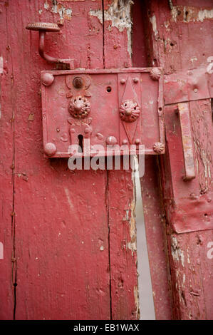 Very old and rusty door lock on a wooden door Stock Photo