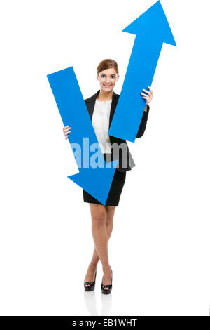 Beautiful young business woman holding a blue arrows, over a white background Stock Photo