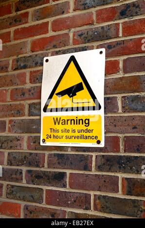 CCTV warning sign on brick wall Stock Photo