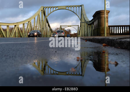 Potsdam, Germany. 24th Nov, 2014. Cars drive over the historical Glinicker Bridge in Potsdam, Germany, 24 November 2014. The bridge, built from 1904-1907, will be closed to traffic for the first time since the fall of the Berlin Wall in November 1989 from Thursday 27 November 2014 to Monday 01 December 2014 for the shooting of a film by American director Steven Spielberg. The bridge is a Cold War symbol; the border between West Berlin and the Soviet Zone bisected the structure. Photo: RALF HIRSCHBERGER/dpa/Alamy Live News Stock Photo