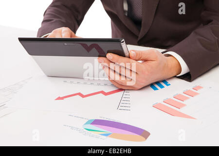 Businessman using tablet PC in office isolated over white. Draft on table Stock Photo