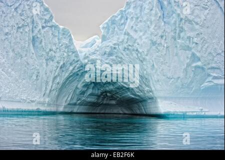Also known as 'Iceberg Graveyard,' Pleneau Island is a labyrinth of icebergs between the towering mountains of Booth Island. It lies north east of Hovgaard Island in the Wilhelm Archipelago and the south end of Lemaire Channel. Stock Photo