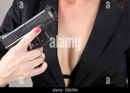 Woman holds handgun Model released Stock Photo