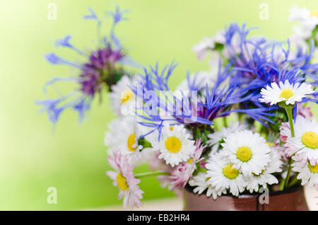 Bouquet of daisies on the table in the garden. Summer background Stock Photo