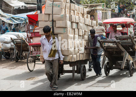 Men transporting goods on a hand cart on Khari Baoli Road, Old Delhi, New Delhi, Delhi, India Stock Photo