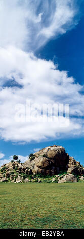 A rocky granite outcrop known as a kopje on a short grass savannah plain. Stock Photo