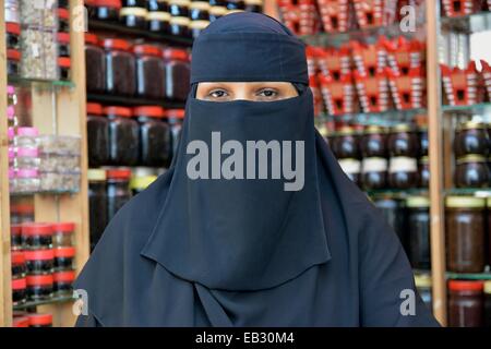 Portrait of a incense seller at her booth on the incense market, Salalah, Dhofar Region, Orient, Oman Stock Photo