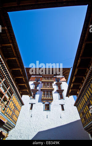 Ornately carved windows and colorful balconies overlook a courtyard in an ancient Buddhist monastery. Stock Photo