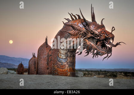 Sculpture of dragon in desert with rising full moon in background, Borrego Springs, California, USA Stock Photo