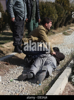 (141125) -- KABUL, Nov. 25, 2014 (Xinhua) -- An Afghan security officer handcuffs a suspected man after a blast in Kabul, Afghanistan on Nov. 25, 2014. A big blast rocked Kabul on Tuesday but caused no casualties, police said. (Xinhua/Ahmad Massoud) (lmz) Stock Photo