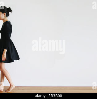 Side view of a Woman walking away Stock Photo