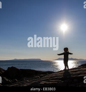 Silhouette of a girl standing with outstretched arms Stock Photo - Alamy