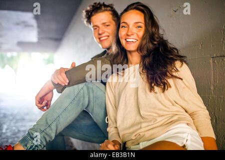 Caucasian couple smiling in tunnel Stock Photo