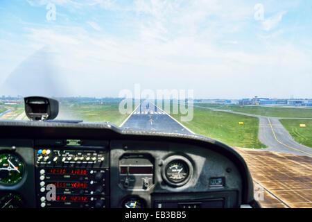 View of an airport runway from the cockpit of an aircraft Stock Photo