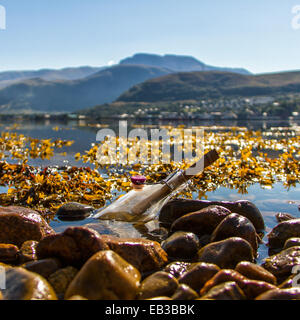 Close-up of a message in a bottle in the sea, Scotland, UK Stock Photo