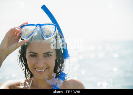 Caucasian woman wearing snorkel and mask in ocean Stock Photo