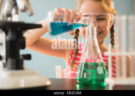 Caucasian girl doing science experiment in lab Stock Photo