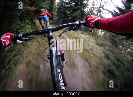 Mountain biker following his friend, Salzburg, Austria Stock Photo