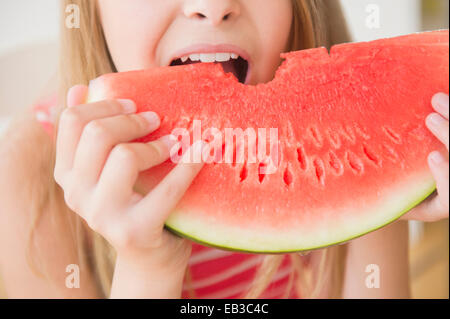 Caucasian girl eating large slice of watermelon Stock Photo