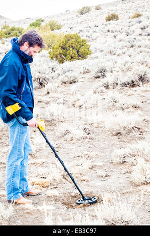 Man using metal detector in Black Rock desert, Nevada, United States Stock Photo