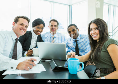 Business people smiling in meeting Stock Photo