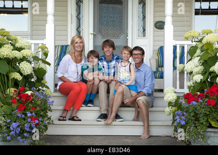 Caucasian family smiling on front porch Stock Photo