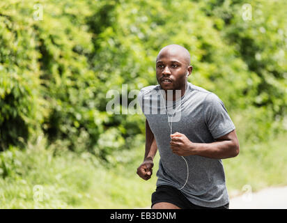 Black man running in park Stock Photo